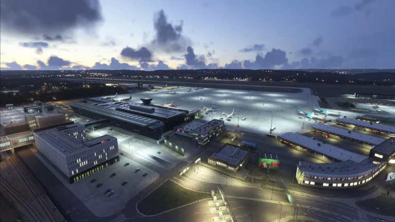 Aerial view of illuminated EPKK Krakow airport terminal at dusk in Microsoft Flight Simulator 2024